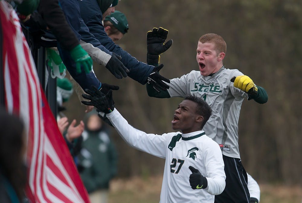 	<p>Junior midfielder Fatai Alashe, 27, and sophomore goalkeeper Zach Bennett celebrate with the Red Cedar Rowdies on Nov. 24, 2013, after defeating Louisville during the second round of the <span class="caps">NCAA</span> tournament at DeMartin Stadium at Old College Field. The Spartans defeated the Cardinals 1-0 in double overtime. Julia Nagy/The State News</p>