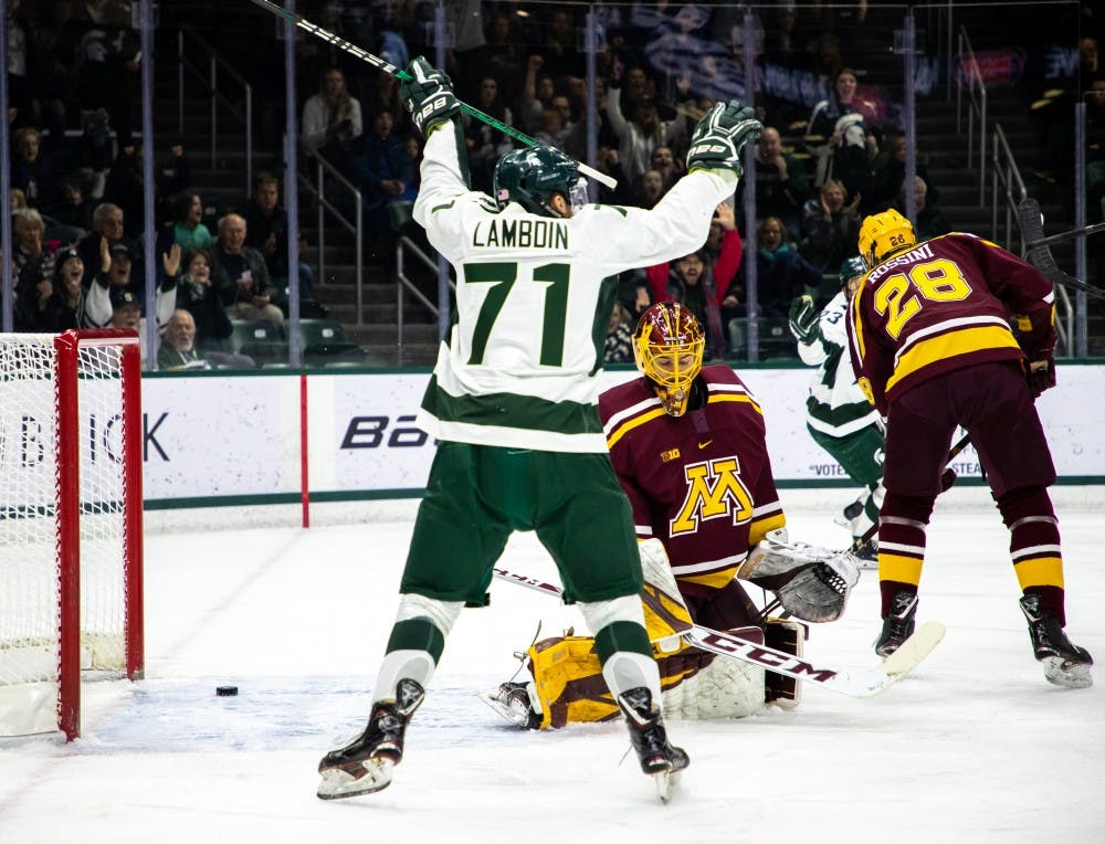 Junior wing Logan Lamdin (71) celebrates a goal during the game against Minnesota on Jan. 20, 2019. The Spartans are tied with the Golden Gophers 1-1 at the end of the first period.