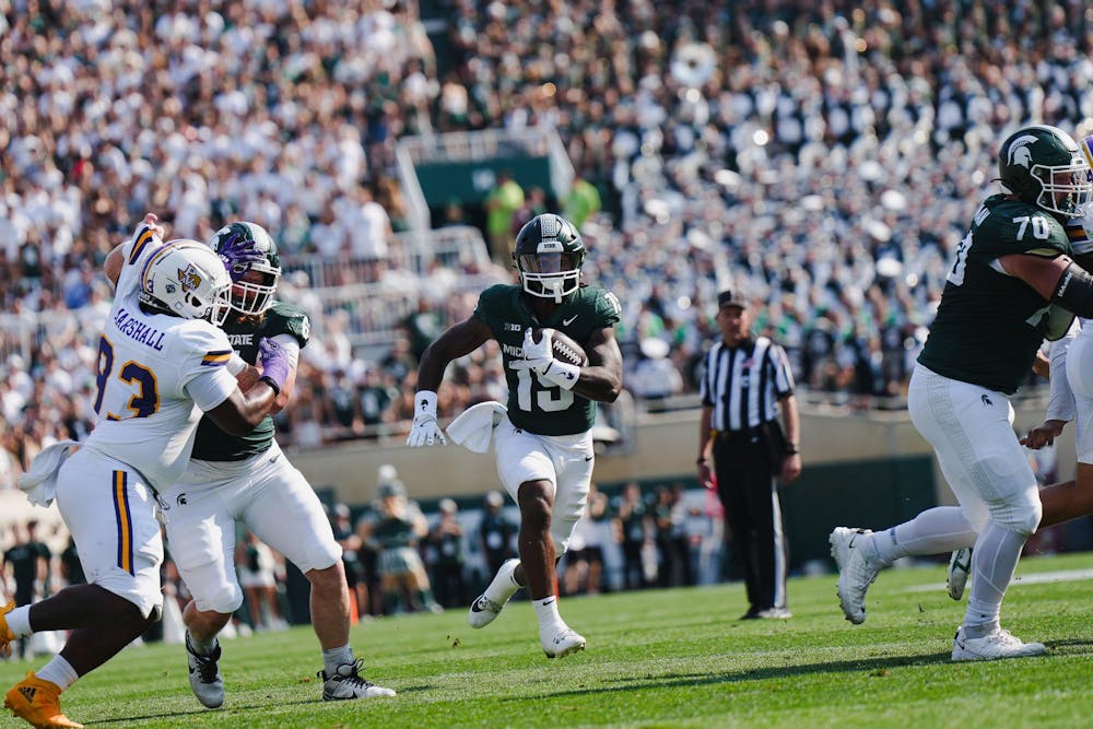 <p>MSU sixth year running-back Kay'ron Lynch-Adams (15) runs the ball through his blocks at Spartan Stadium on Sept. 14, 2024</p>