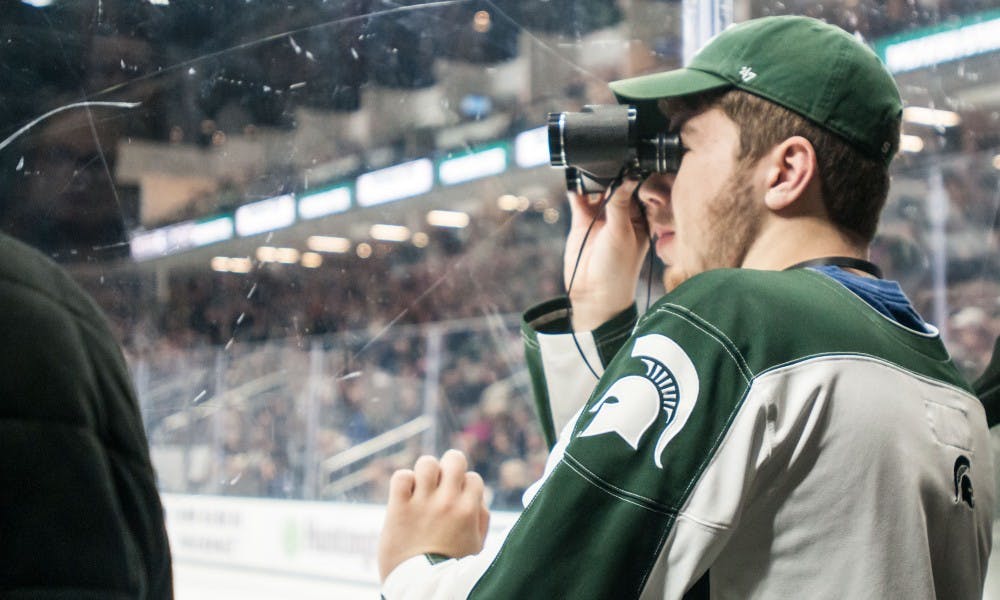 Spartans fan Matthew Miller watches the game against Notre Dame on Dec. 2, 2017, at Munn Ice Arena. The Spartans fell to the Fighting Irish, 2-0.