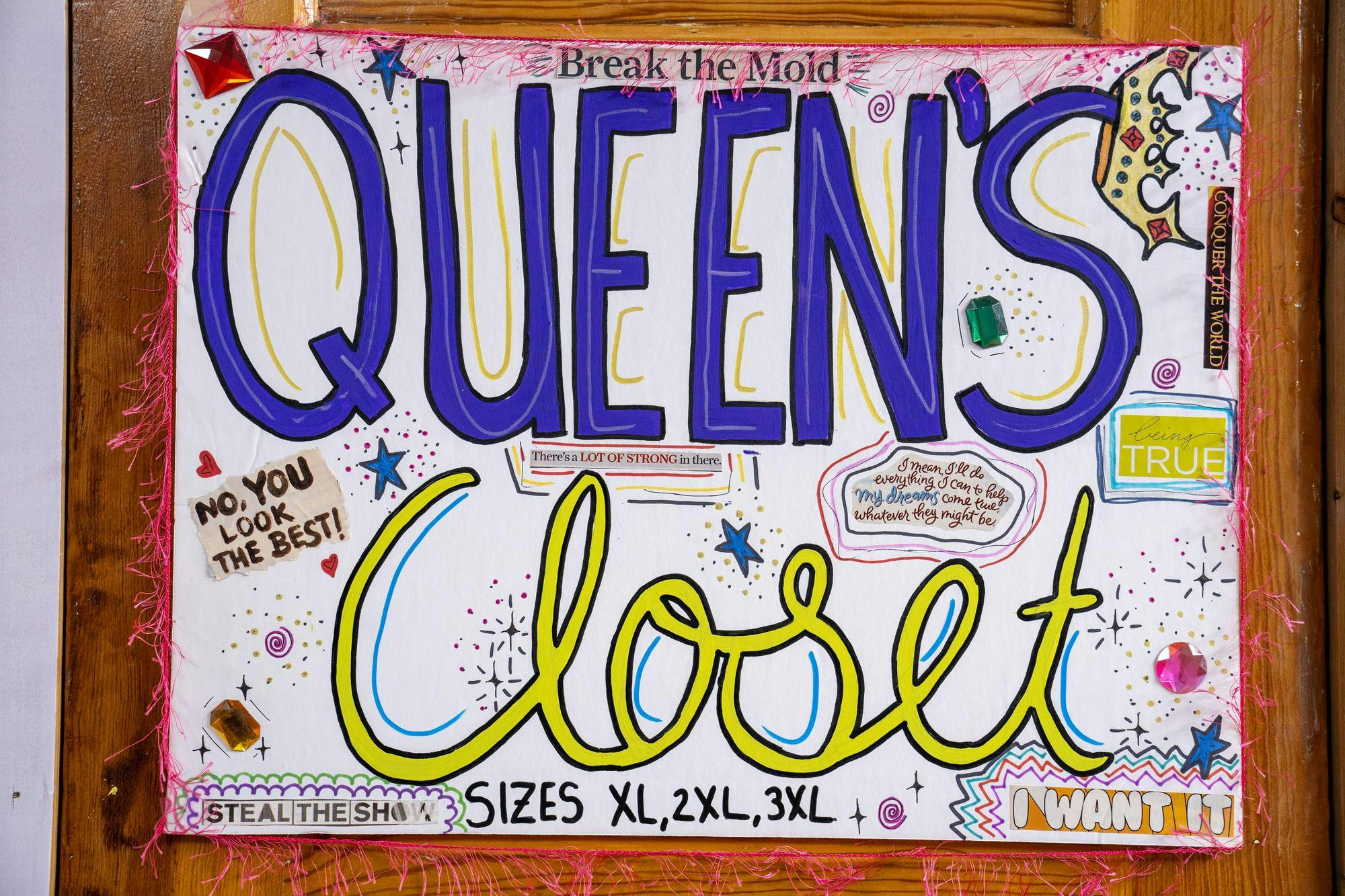 <p>"Queens Closet" signage hung in the Career Boutique, a service offered by the Women's Center of Greater Lansing, on Oct. 18, 2023.</p>