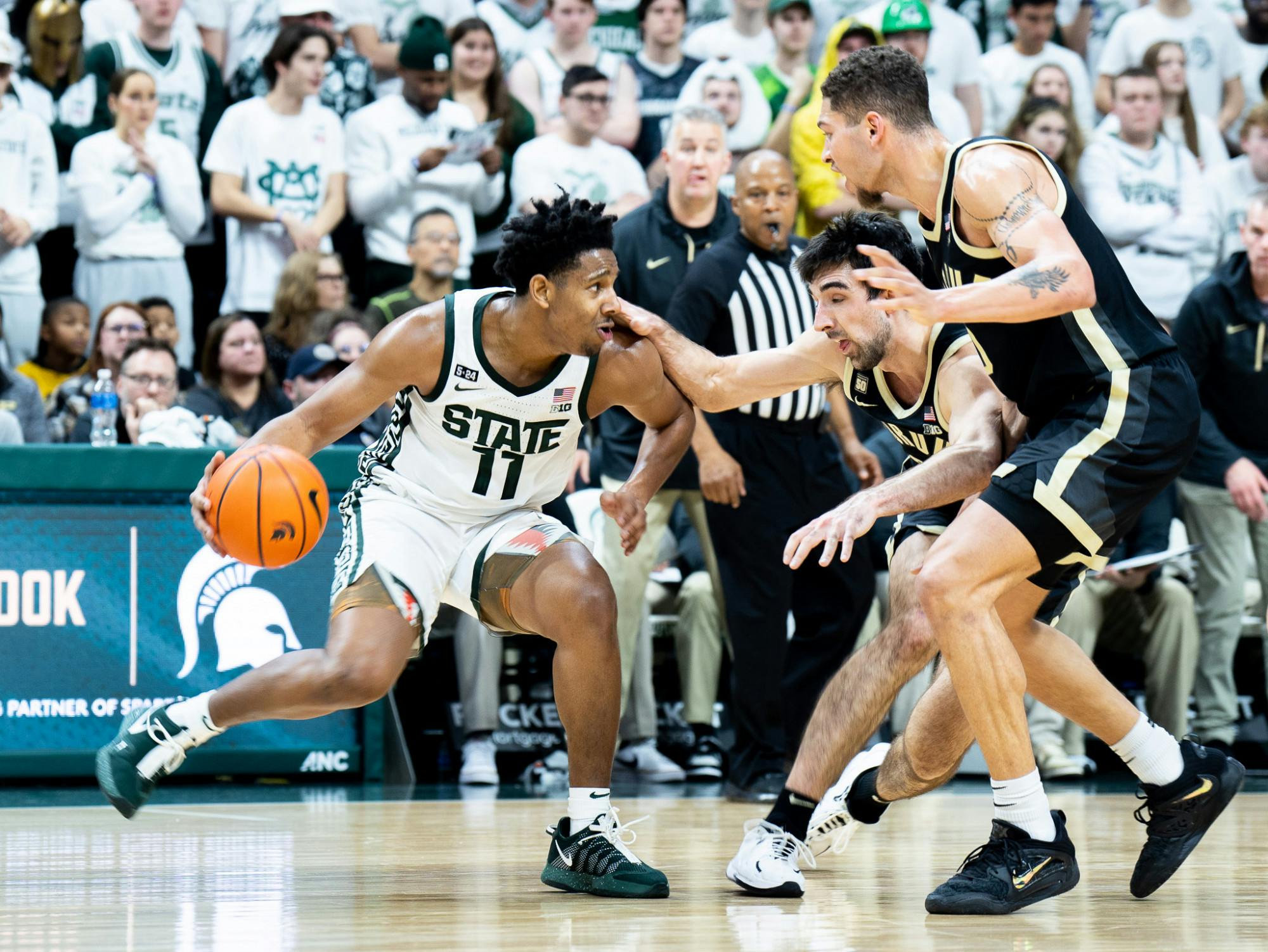 <p>Junior guard AJ Hoggard (11) tries to get past Purdue University player during a game at Breslin Center on Jan. 16, 2023. The Spartans fell to the Boilermakers with a score of 64-63. </p>