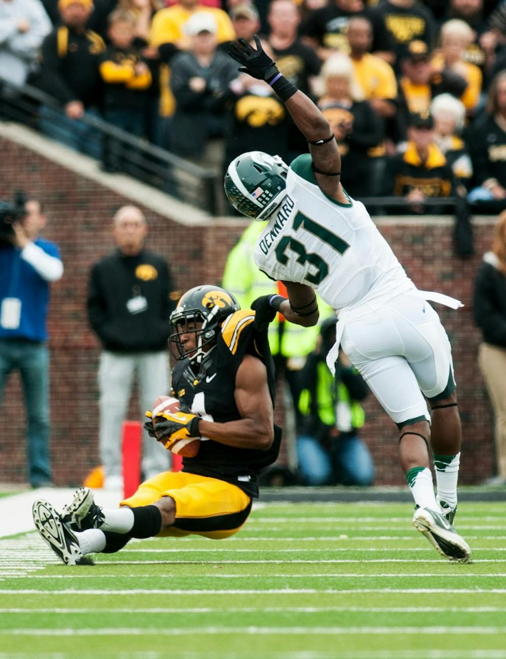 	<p>Senior cornerback Darqueze Dennard takes down Iowa wide receiver Tevaun Smith during the game Oct. 5, 2013, at Kinnick Stadium in Iowa City, Iowa. The Hawkeyes are leading the Spartans 14-10 at halftime. Danyelle Morrow/The State News</p>