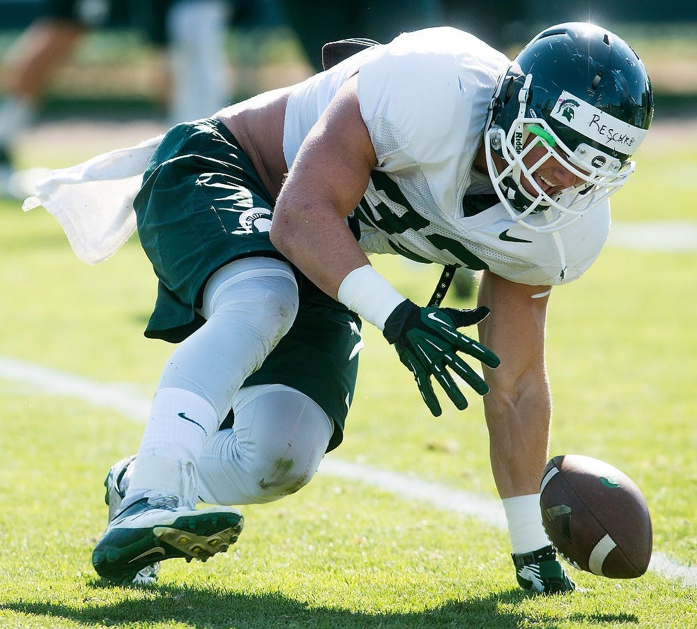 <p>Redshirt freshman linebacker Jon Reschke participates in drills during practice on Aug. 14, 2014, at the practice field outside of Duffy Daugherty Football Building. The season kicks off Aug. 29, with a game against Jacksonville State. Danyelle Morrow/The State News</p>
