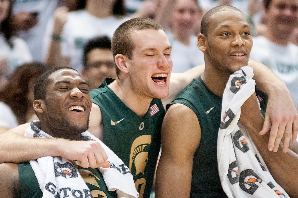 	<p>Sophomore guard Branden Dawson, left, freshman forward Matt Costello, center, and junior center Adreian Payne celebrate during the final minutes of the game as <span class="caps">MSU</span> pulls away from Northwestern. The Spartans defeated the Wildcats, 71-61, on March 10, 2013, at Breslin Center. Justin Wan/The State News</p>