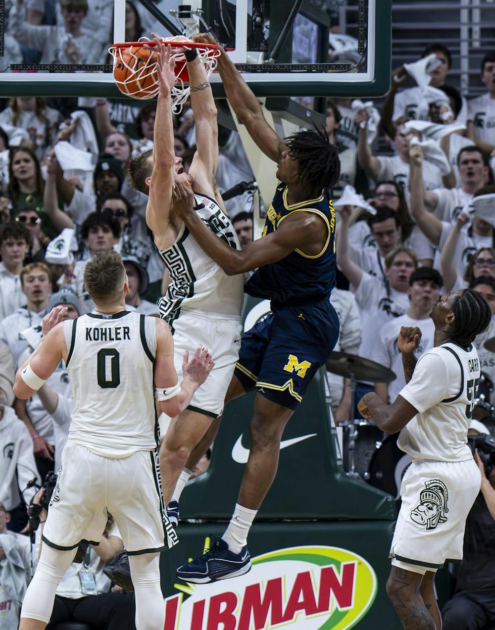 <p>MSU senior center Carson Cooper (15) jumps to block UM sophomore forward Morez Johnson Jr. (21) as he makes a basket at the Breslin Student Events Center on Jan. 30, 2026.</p>