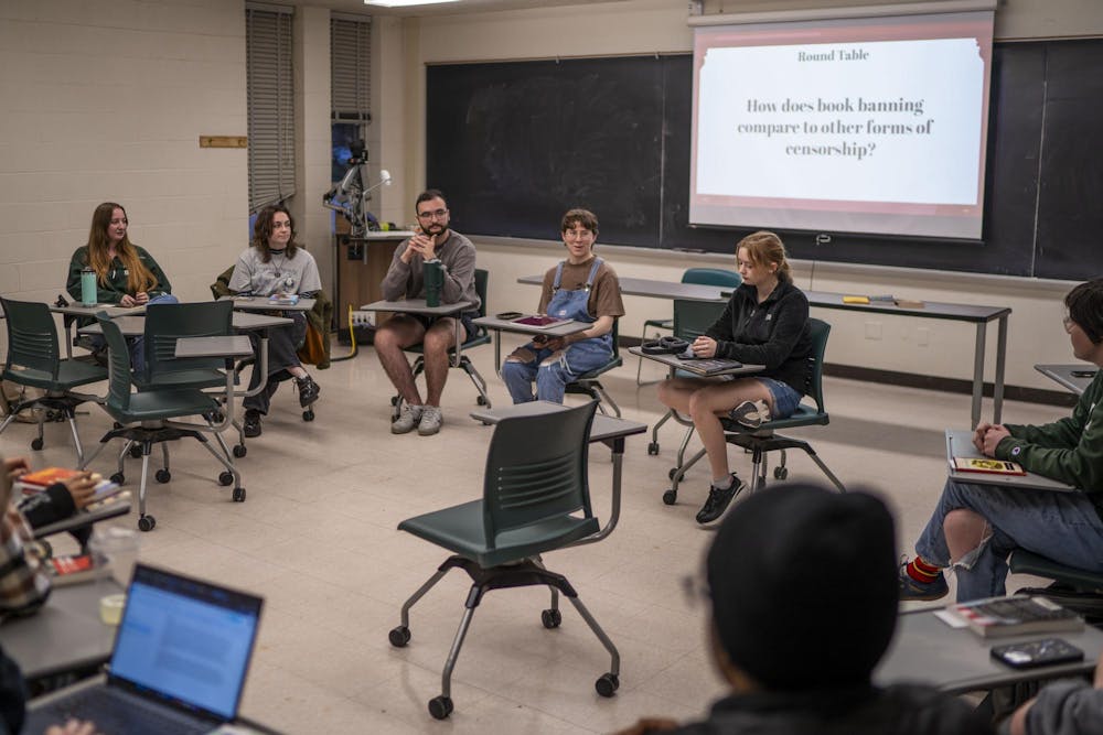 Sigma Tau Delta English Honors Society President and English senior Sydney Logsdon leads a discussion during the club's Banned Book Night at Wells Hall on April 21, 2025.