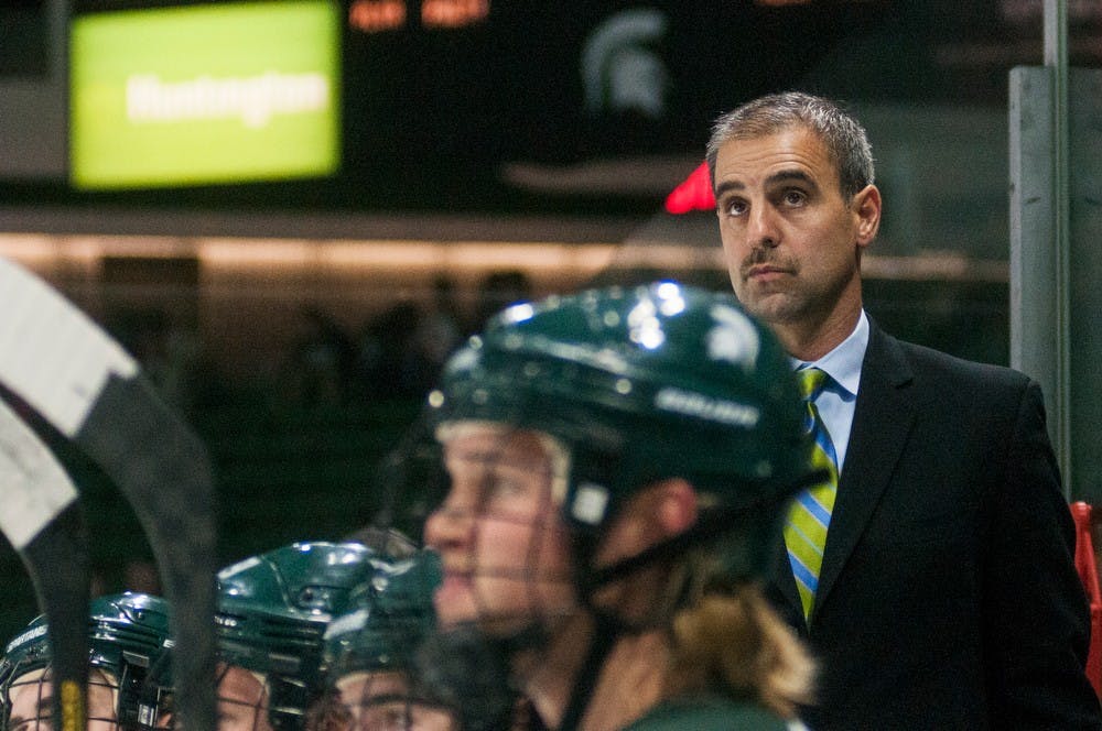 	<p>Head coach Tom Anastos watches the game with Spartan players from the bench during the game against Western Ontario on Oct. 9, 2013, at Munn Ice Arena. The Spartans defeated the Mustangs, 4-1, in the first exhibition game of the season. Danyelle Morrow/The State News</p>