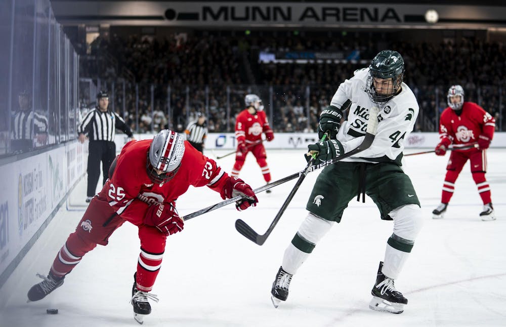 <p>MSU sophomore defense Colin Ralph (4) and OSU junior forward Sam Deckhut (25) race after the puck in Munn Ice Arena on March 14, 2026. Ohio State defeated Michigan State 3-2 in overtime.</p>