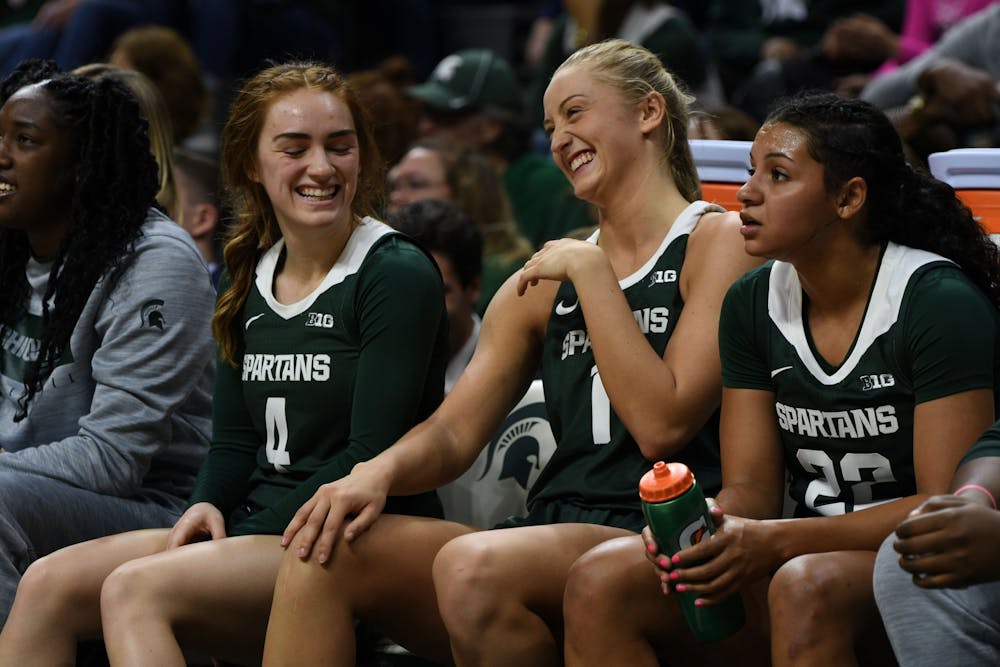 Spartan teammates, McCutcheon and sophomore guard/forward Tory Ozment (1), share a laugh while sitting on the bench during their game against Hartford. The Spartans crushed the Hawks, 79-34, on Nov. 24, 2019. 