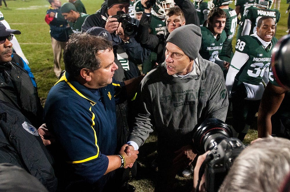 	<p>Head coach Mark Dantonio and Michigan head coach Brady Hoke exchange handshakes after the game against Michigan on Nov. 2, 2013, at Spartan Stadium. The Spartans defeated the Wolverines, 29-6. Khoa Nguyen/The State News</p>