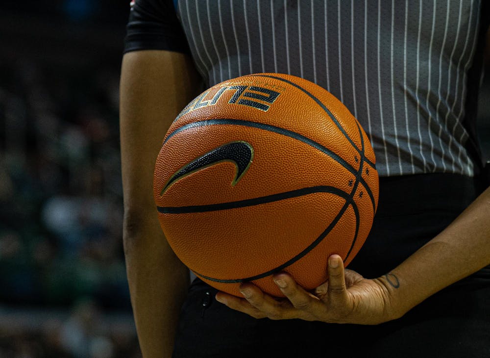 A close up look at a game ball being held by a ref during the MSU versus Eastern Michigan Women's Basketball game at Michigan State University's Breslin Center on Sunday, Nov. 9, 2025