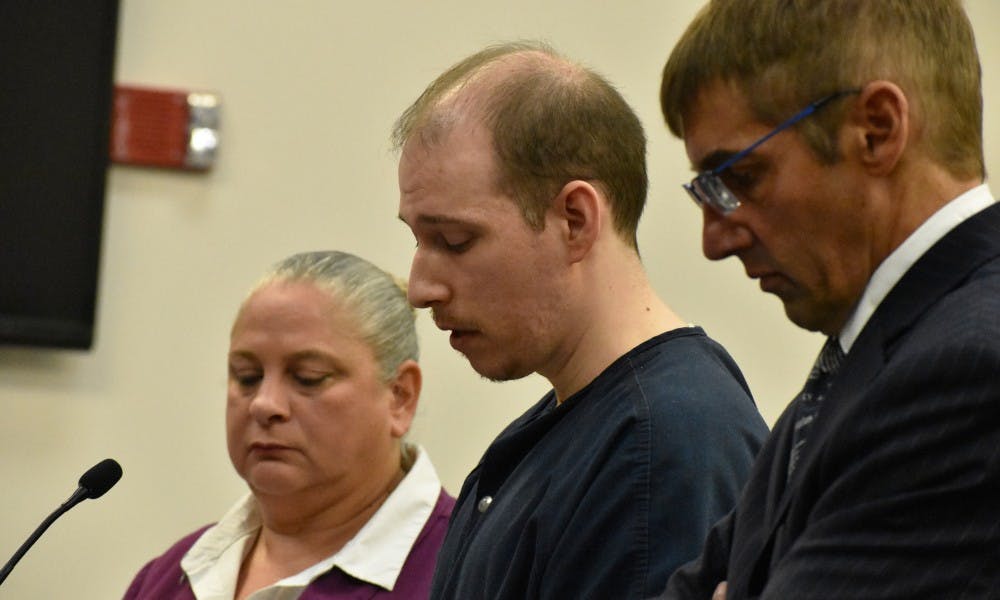 <p>Michael Phinn reads his testimony before the judge, which included apologies to his wife and son for behaving the way he did. Phinn&#x27;s trial took place in Ingham County on Sept. 18. </p>