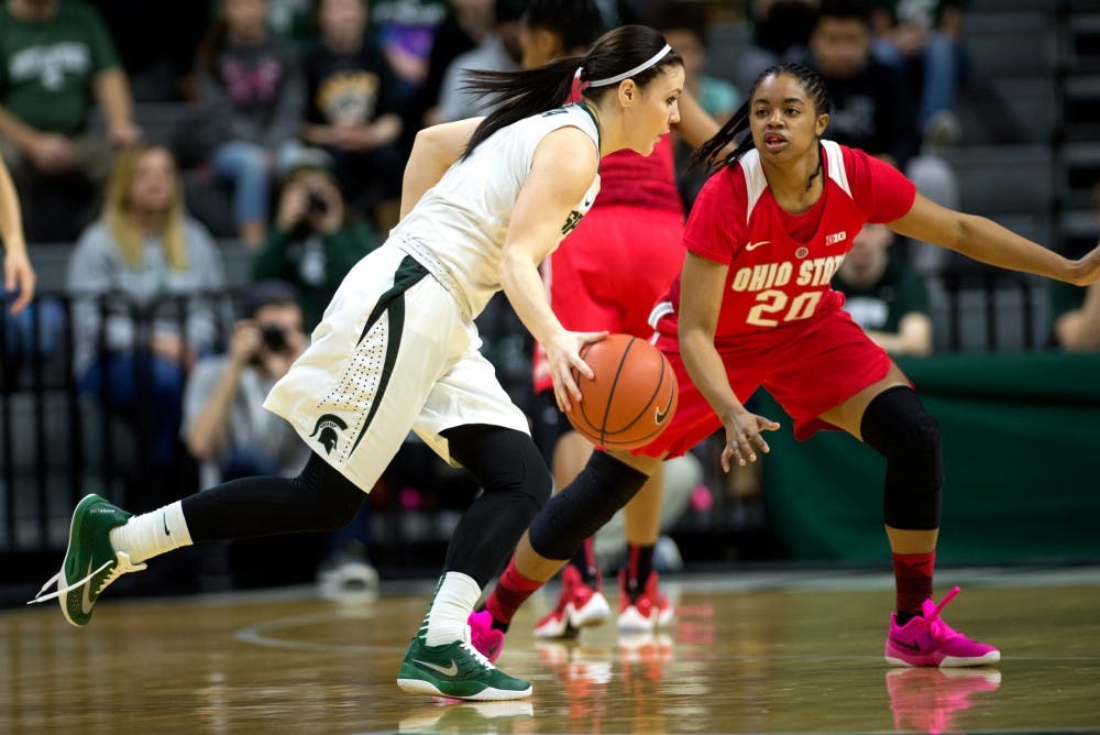 Junior guard Tori Jankoska goes for the net as she is defended by Ohio State guard Asia Doss during the game against Ohio State on Feb. 27, 2016 at Breslin Center. The Spartans defeated the Buckeyes, 107-105 in triple overtime.