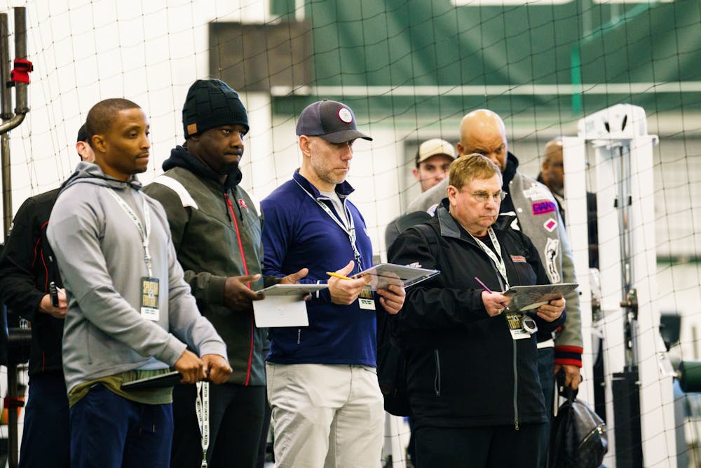 Professional football scouts observe athletes during MSU Football's pro day, hosted at the Duffey Daughtery Football Building on March 15, 2023.