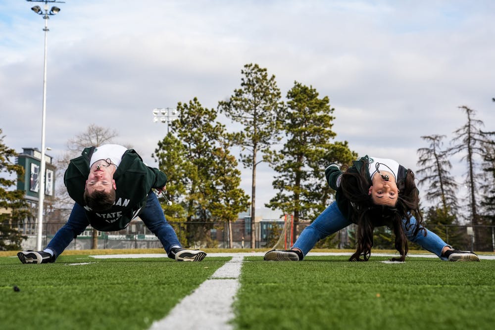 <p>Michigan State University drum majors Tom McGovern and Lacy Jewell at Munn Practice Field on Feb. 11, 2024. One of the key tricks the drum majors put on at games is a back bend. </p>