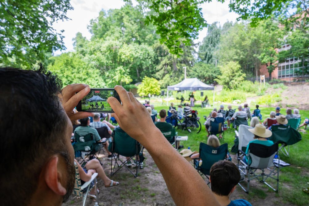 <p>MSU College of Music Graduate Advisor Michael Armendariz records the performance of the MSU Go Music Trio during the Music and the Garden event in East Lansing, Mich., on June 28, 2026.</p>
