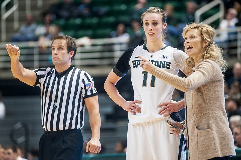 	<p>From left, game official Rod Creech signals to other game officials as head coach Suzy Merchant talks will players on the floor with junior forward Annalise Pickrel standing next to her. The Spartans defeated the Hawkeyes, 65-54, Thursday, Jan. 17, 2013, at Breslin Center. Justin wan/The State News</p>
