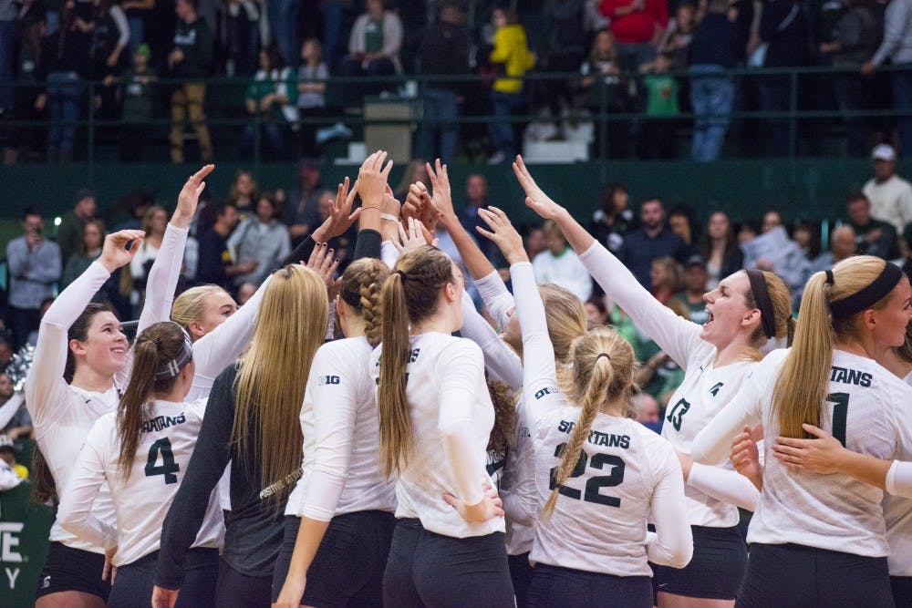 The team rushes the court after the game against Michigan on Nov. 12, 2016 at Jenison Fieldhouse. The Spartans defeated the Wolverines, 3-1. 