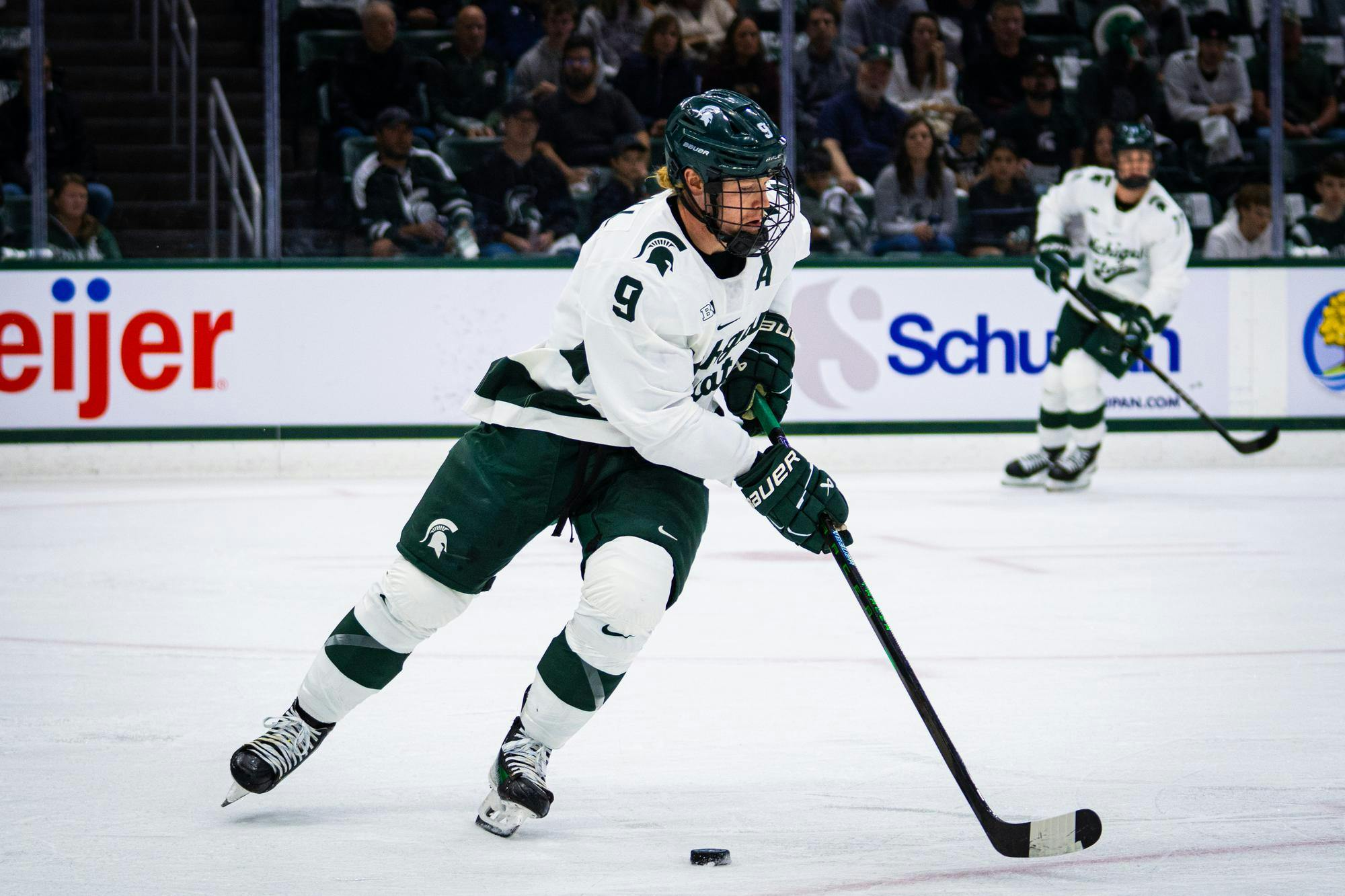 <p>MSU junior defenseman Matt Basgall (9) receives a pass from a teammate during a match at Munn Ice Arena on Oct. 11, 2024.</p>