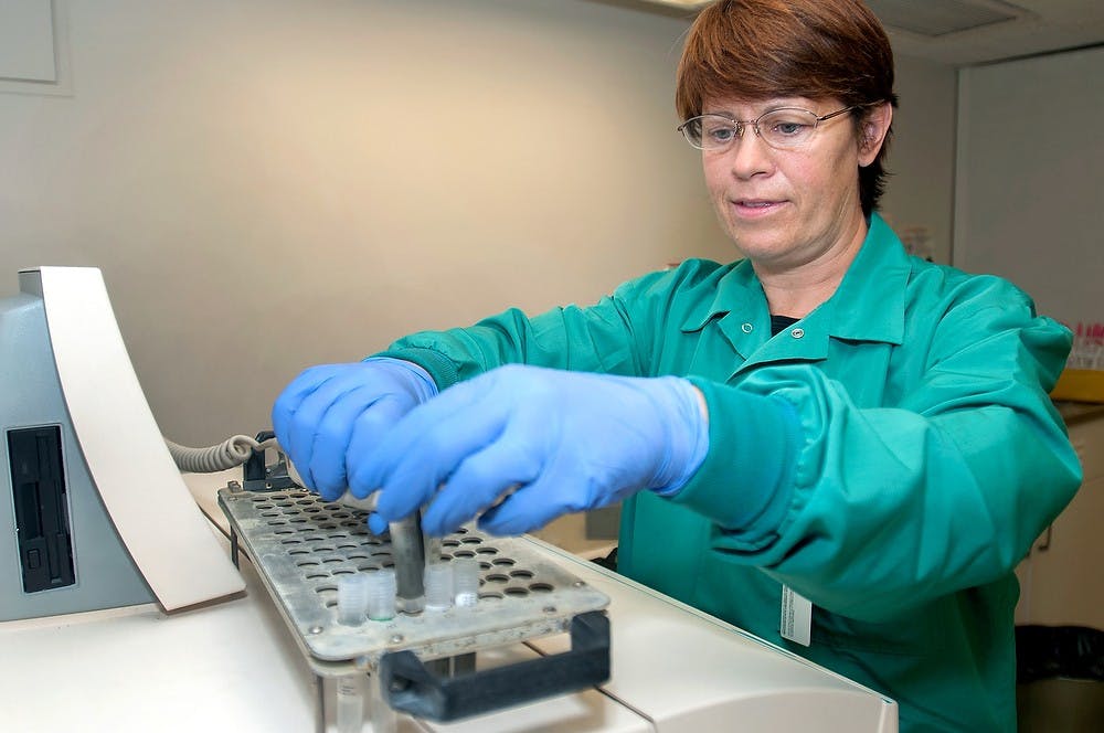 	<p>Med tech Nancy Nagele scans the barcode on samples for chlamydia on Tuesday, Oct. 9, 2012 in the Olin Health Center Laboratory. Nagele was repeating a run to ensure the sample was actually positive for chlamydia. Julia Nagy/The State News</p>