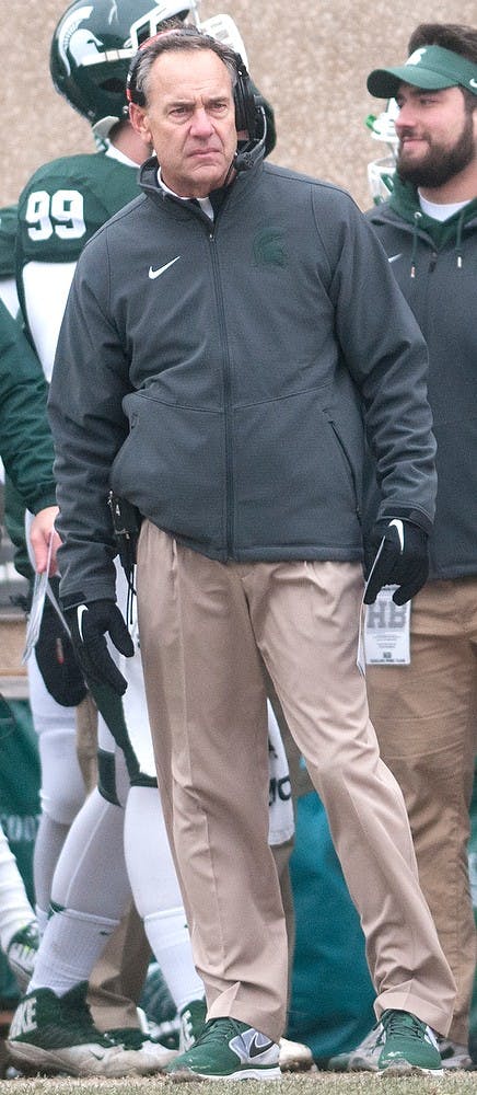 <p>Head coach Mark Dantonio watches the game Nov. 22, 2014, during the game against Rutgers at Spartan Stadium. The Spartans defeated the Scarlet Knights, 45-3. Jessalyn Tamez/The State News </p>