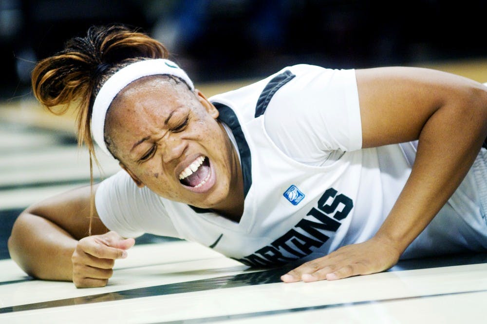 Redshirt senior forward Lykendra Johnson lies on the floor after an injury. Miami defeated the Spartans, 76-60, Thursday night at Breslin Center. Justin Wan/The State News