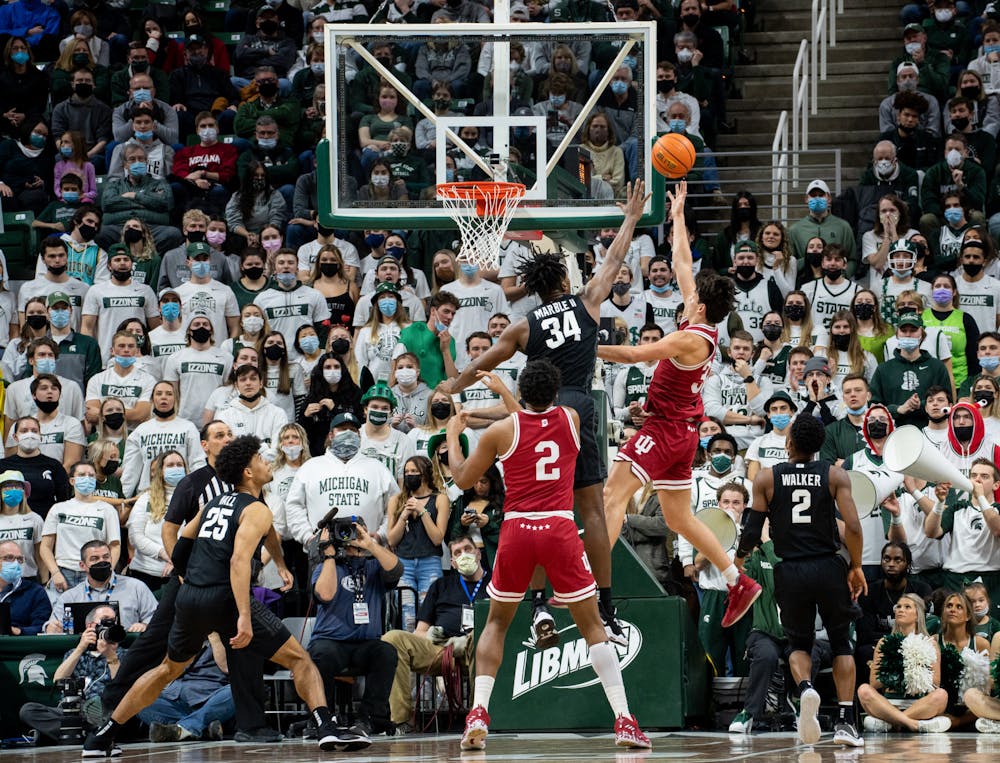 <p>Michigan State junior forward Julius Marble II (34) attempts to block a shot by Indiana&#x27;s sophomore guard Trey Galloway (32) during Michigan State&#x27;s victory over Indiana on Feb. 12, 2022.</p>