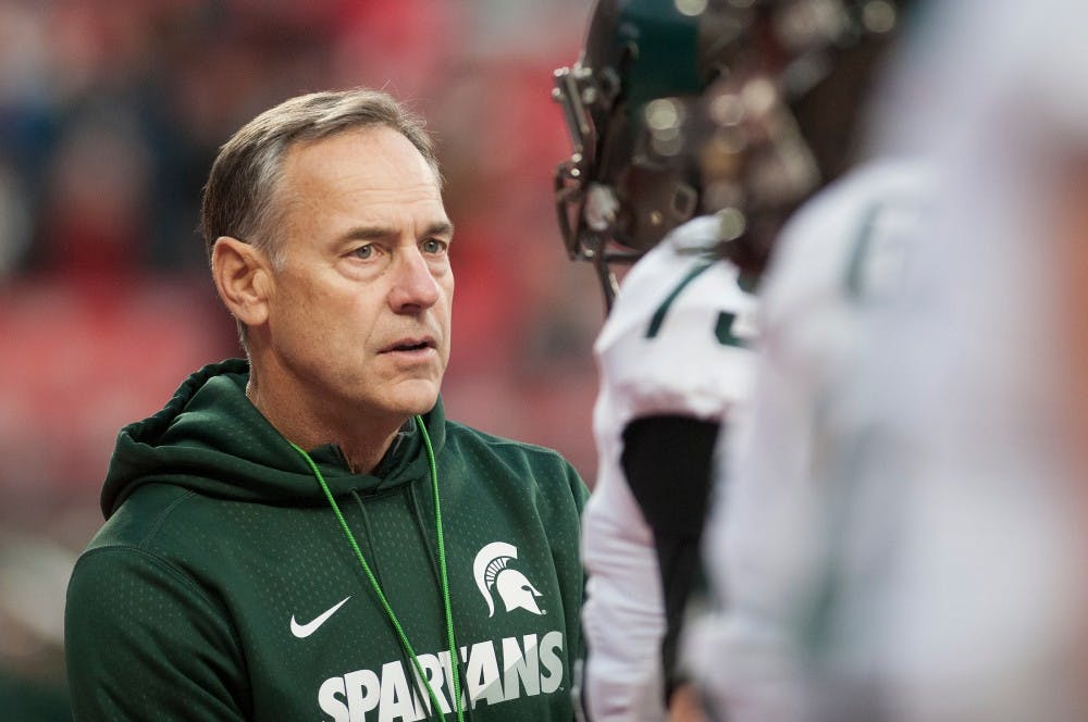 <p>Head coach Mark Dantonio speaks with a player prior to the game against Ohio State on Nov. 21, 2015 at Ohio Stadium in Columbus, Ohio. The Spartans defeated the Buckeyes, 17-14. </p>
