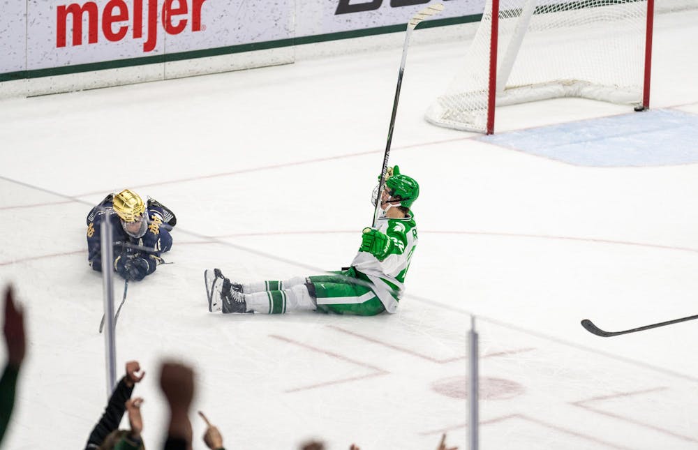 MSU Fr. F, Porter Martone (22), scores a goal sitting and sliding across the ice after Notre Dame leaves an open net in Munn Ice Arena in East Lansing, MI on Feb. 19, 2026.