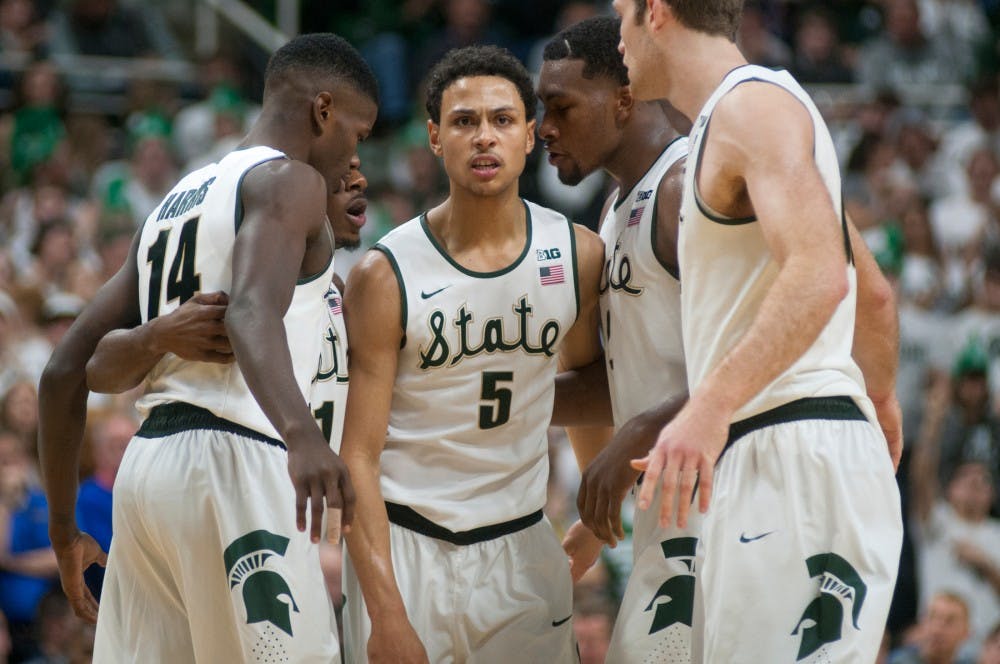 Senior guard Bryn Forbes, 5, celebrates with his team after scoring on Dec. 12, 2015 during the game against Florida at Breslin Center. The Spartans defeated the Gators, 58-52.
