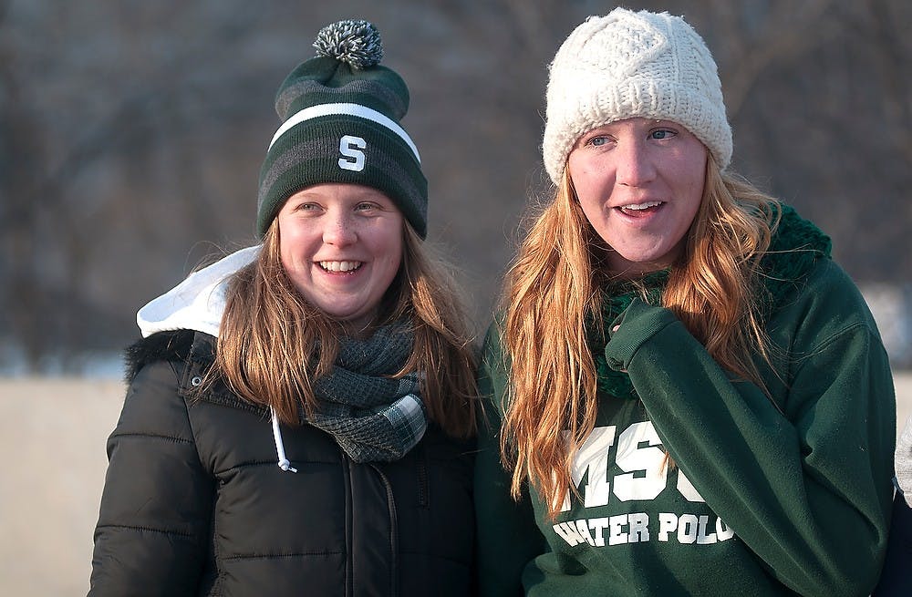 <p>MSU alumna and East Lansing resident Alison Judson (Left) and MSU alumna Krystal Krejcik tailgate Feb. 7, 2015, prior to the Michigan State hockey game against Michigan at Soldier Field in Chicago, Illinois.  The Spartans will take on the Wolverines as part of the Coyote Logistics Hockey City Classic. Alice Kole/The State News</p>