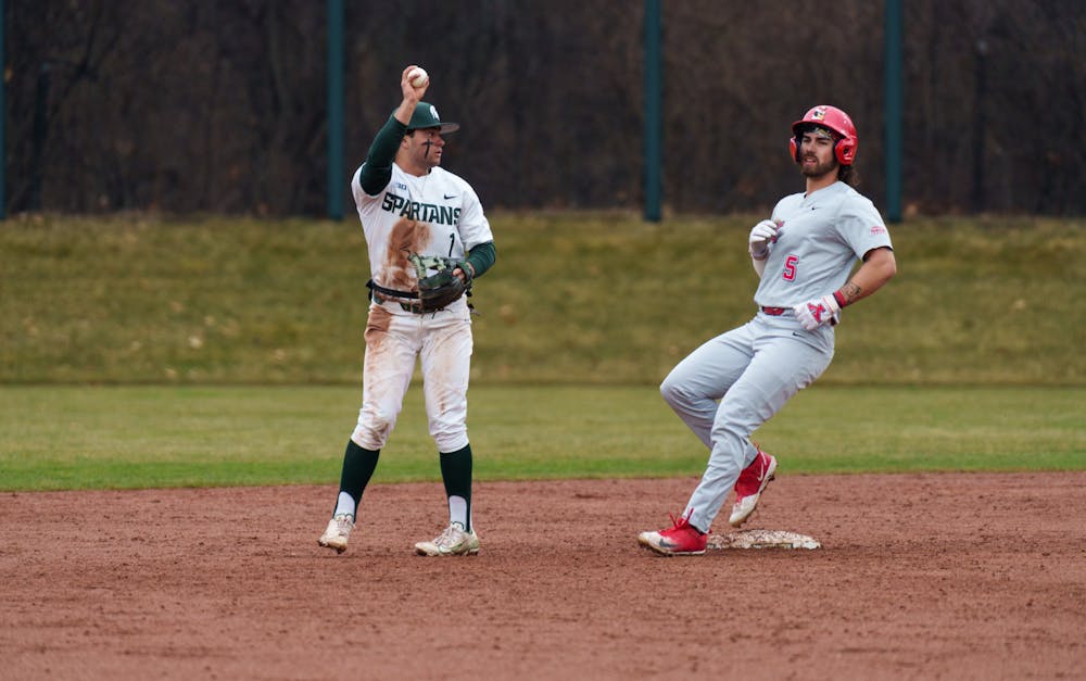 <p>Michigan State sophomore Brent Farquhar shows officials he has the ball making Youngtown State senior Dominick Bucko out at McLane Baseball Stadium on March 30, 2022. Spartans are victorious 12-5 against Youngtown State.</p>
