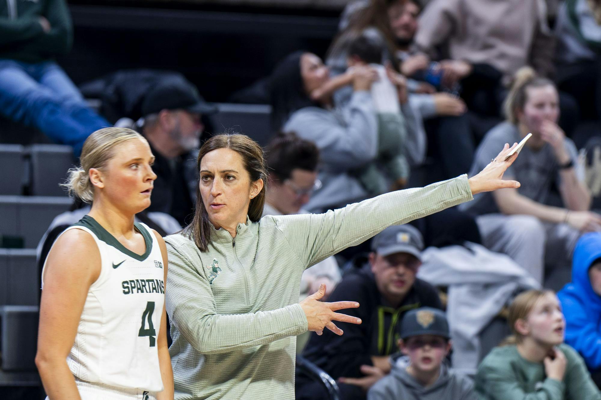 <p>Michigan State women's basketball head coach Robyn Fralick talks to junior guard Theryn Hallock (4) as she runs off the court at the Breslin Center on Jan. 22, 2025.</p>