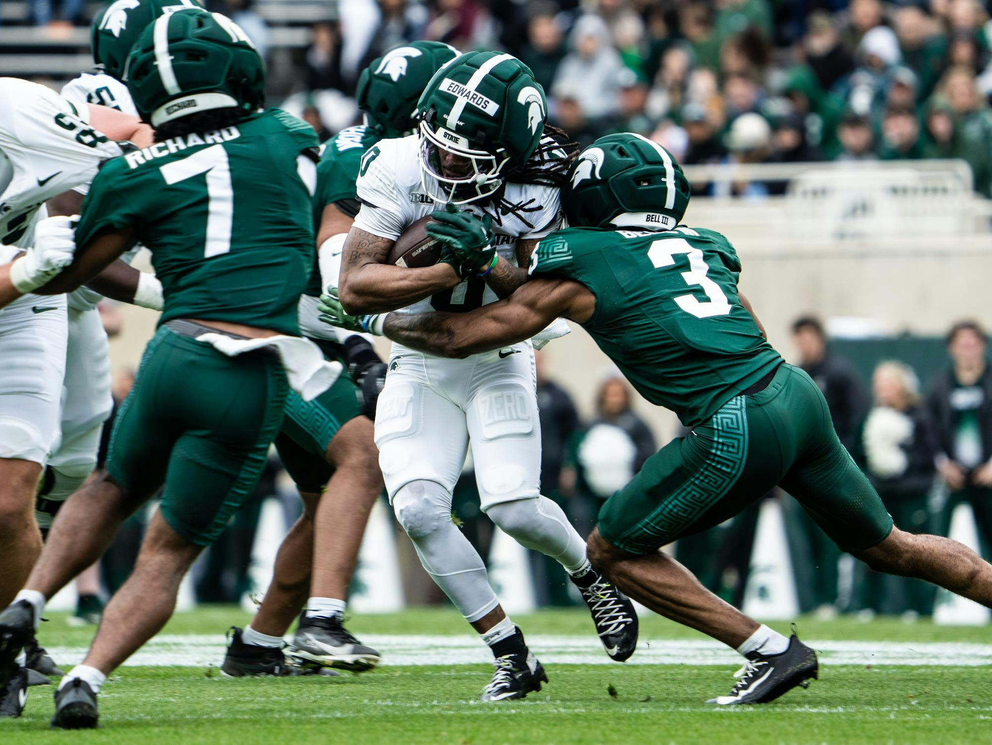 <p>Michigan State R-Sr. running back, Cam Edwards (0) tries to push through his fellow teammate R-Sr. cornerback, Tre Bell III (3) during the Spring Showcase at Spartan Stadium on Saturday, April 18, 2026 in East Lansing, Michigan .</p>