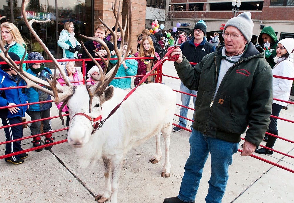 	<p>Co-owner of Rooftop Landing Reindeer Farm Dave Aldrich displays a reindeer named Blizzard at Winter Glow on Saturday, Dec. 1, 2012, in downtown East Lansing. Winter Glow included a kid&#8217;s carnival, ice carving and carriage rides, among other activities. Katie Stiefel/ State News</p>