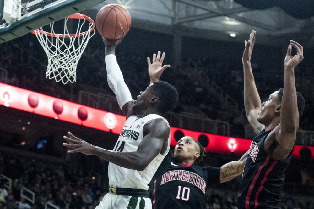 Senior guard Eron Harris (20) shoots and scores a basket during the game against Northeastern on Dec. 18, 2016 at Breslin Center. The Spartans were defeated by the Huskies, 73-81. 