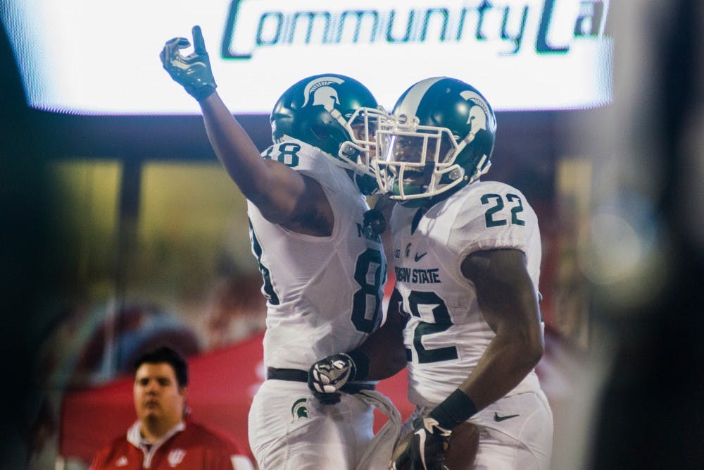 Senior running back Delton Williams (22) and senior wide receiver Monty Madaris (88) celebrate after Williams scored a TD during the game against Indiana on Oct. 1, 2016 at Memorial Stadium in Bloomington, Ind. The Spartans were defeated by the Hoosiers in overtime, 24-21.