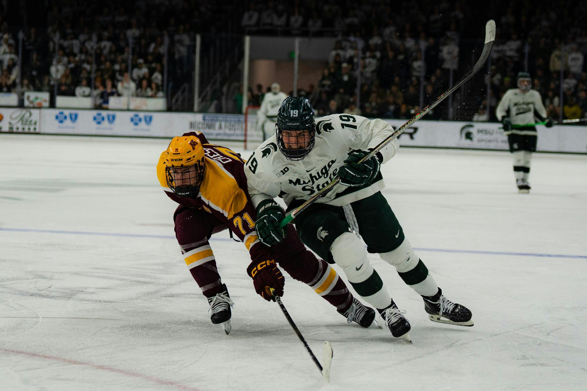 <p>Michigan State freshman Mikey DeAngelo (19) battles a Minnesota defender for the puck at Munn Ice Arena on Jan. 24, 2025.</p>