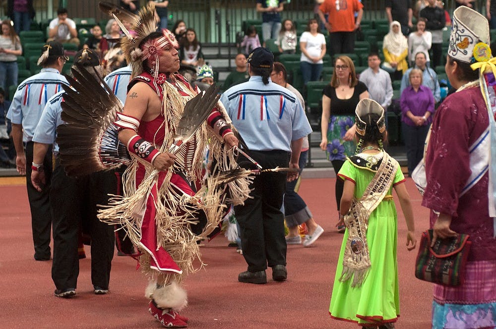 <p>A man dances April 18, 2015, at the NAISO 32nd Annual Pow Wow of Life at Jenison Field House. Native people consider their dress a form of maintaining their culture and identity and do not consider their outfit as costume, a term many others mistake them for. Allyson Telgenhof/The State News.</p>