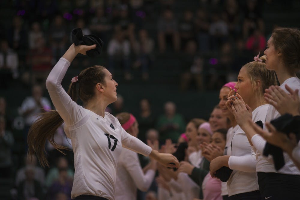 Junior middle blocker Alyssa Graveling (17) throws a t-shirt to the crowed after being introduced on the court before the game against Rutgers on Oct. 19, 2016 at Jenison Fieldhouse The Spartans defeated the Scarlet Knights, 2-1.