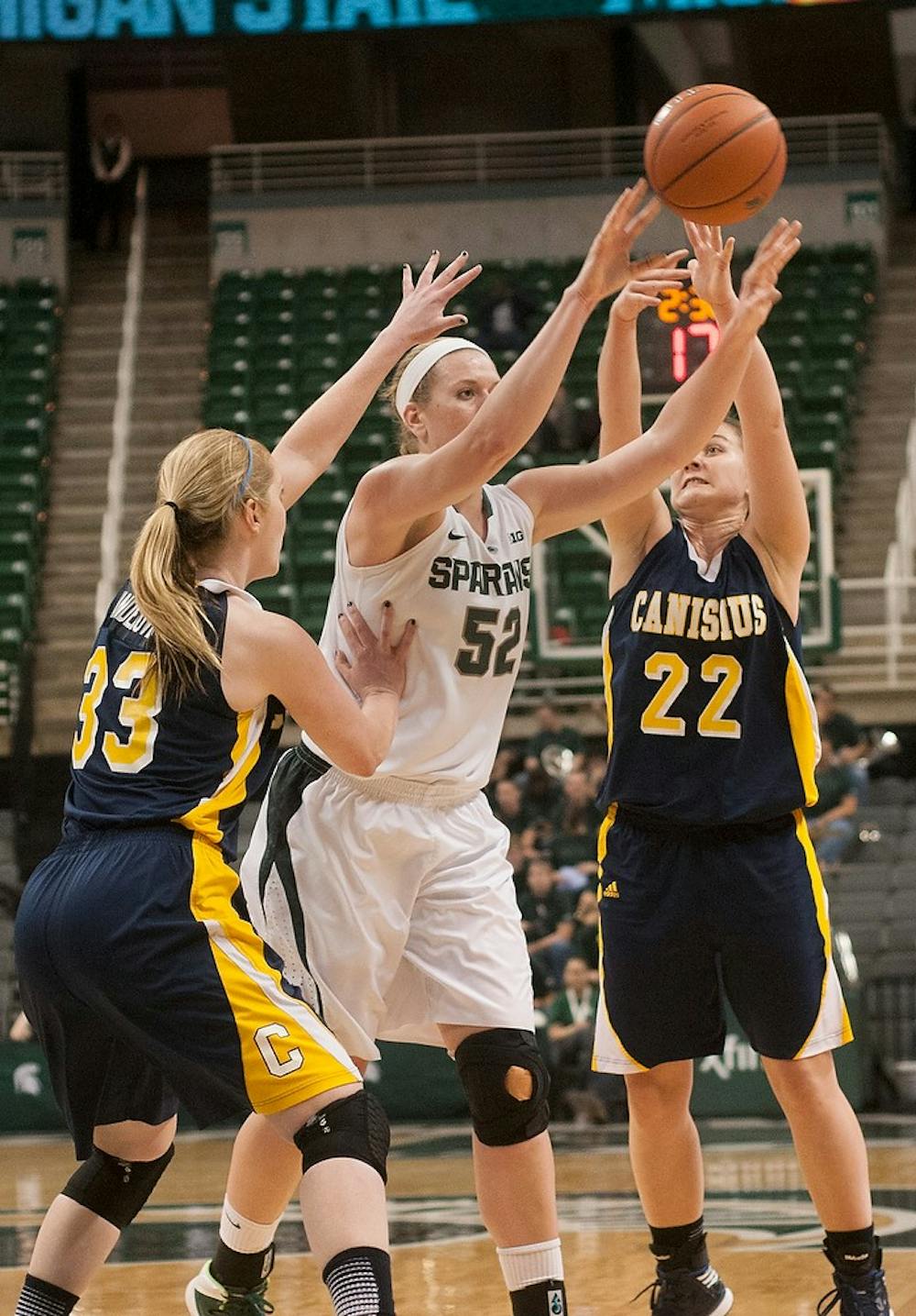 	<p>Junior forward Becca Mills takes a shot around Canisius forward Courtney VandeBovenkamp, 33, and guard Tamara Miskovic, 22, during the game Nov. 14, 2013, at Breslin Center. <span class="caps">MSU</span> defeated Canisius 102-54. Brian Palmer/The State News</p>