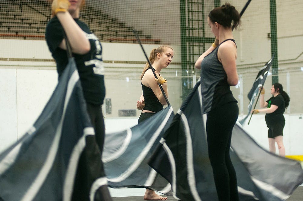 <p>Biomedical laboratory science freshman Alyssa Hicks performs during a MSU State of Art Winter Guard practice March 8, 2014, at Demonstration Hall. The guard is traveling to Cincinnati, Ohio, in order to compete with a routine they have been working on throughout the season. Danyelle Morrow/The State News</p>