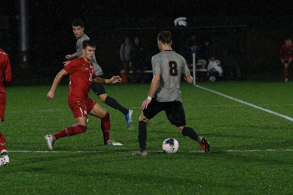 <p>Redshirt sophomore midfielder Alex Shterenberg tries to make it around a defender during the game against Maryland at DeMartin Field on October 11, 2019. The Spartans tied the Terrapins 1-1.</p>