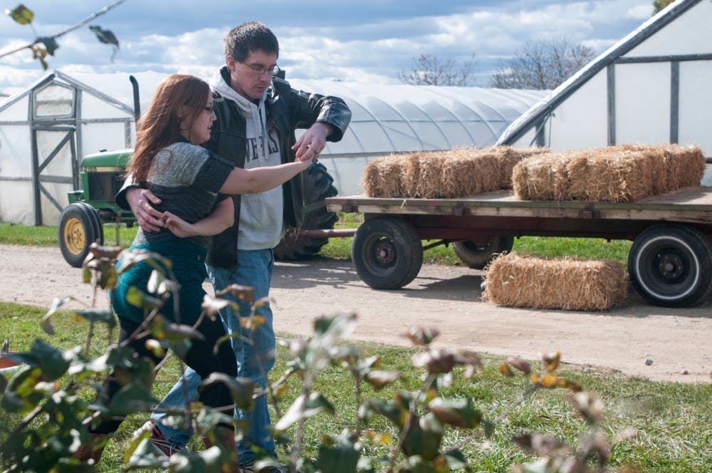 <p>Veterinary medicine students Ashley Cooley and Matt Ford dance on Oct. 17, 2015 at the Harvest Fest event run by the Ecological Food and Farm Stewardship Club at the Student Organic Farm. The club focuses on local and sustainable agriculture and puts on events like Harvest Fest to engage the community. </p>