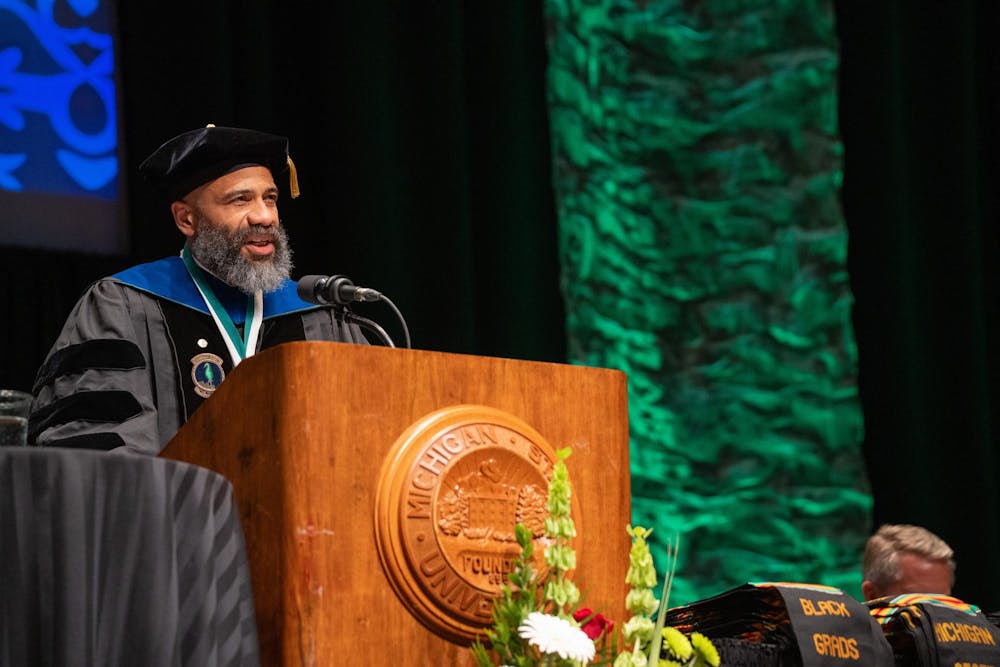 Vice Provost for Graduate and Postdoctoral Studies Pero Dagbovie congratulates Michigan State students during the Black Graduation ceremony at the Wharton Center on April 21, 2024.