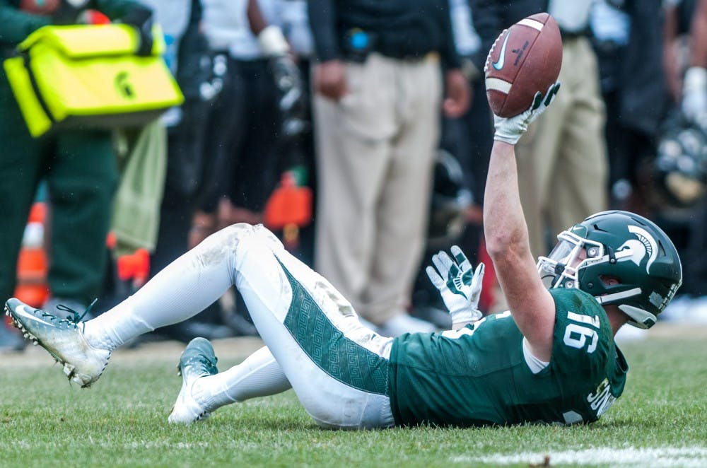 Senior wide receiver Brandon Sowards holds the ball up after making a catch during the game against Purdue on Oct. 27, 2018 at Spartan Stadium. The Spartans defeated the Boilermakers 23-13.