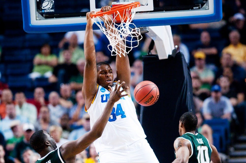 <p>UCLA center Joshua Smith dunks over then-junior forwards Draymond Green and Delvon Roe in the second half. The Spartans lost to UCLA, 78-76, in the second round of the NCAA Tournament on March 18, 2011, at St. Pete Times Forum in Tampa, Florida. </p>