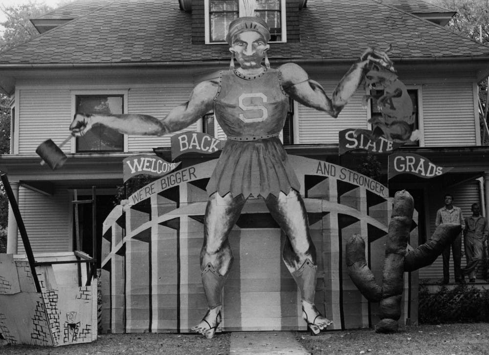 <p>A cutout of what appears to be a Spartan holding a hammer and a dead rodent is staged in front of an East Lansing house homecoming weekend 1948. According to bigten.org, Michigan State College (now MSU) would be added to the Big Ten Conference the following year.</p>
