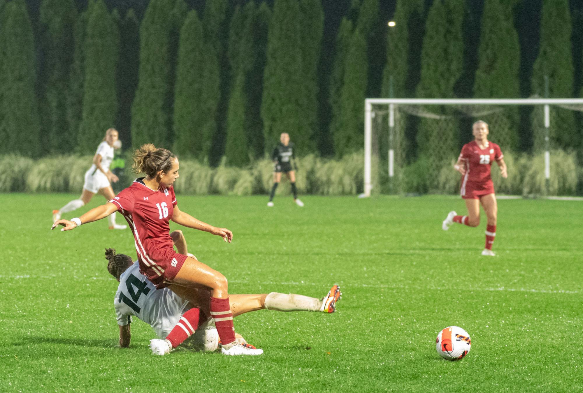 <p>Michigan State&#x27;s fifth-year senior forward Ava Cook (14) falls with Wisconsin&#x27;s redshirt sophomore defender Gabby Green (16) during Michigan State&#x27;s loss to Wisconsin on Sept. 23, 2021.</p>